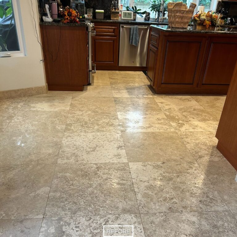 Travertine kitchen floor in West Hollywood before refinishing, with dull, worn tiles lacking shine.