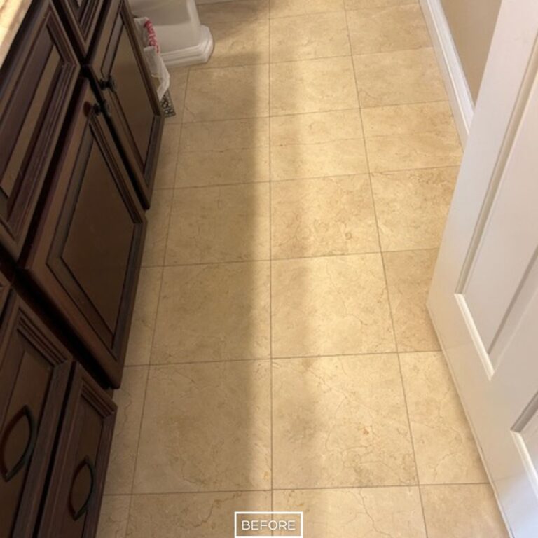 Travertine bathroom floor in Walnut home before restoration, showing dull surface with minimal shine near vanity cabinets.