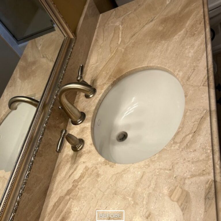 Worn travertine countertop in Walnut bathroom before restoration, with faded surface and lack of polish around sink area.