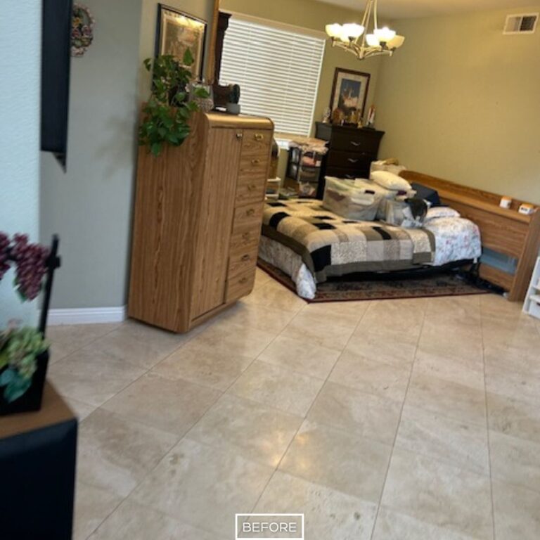 Before travertine floor restoration in Orange showing dull tiles and dirty grout in bedroom area.