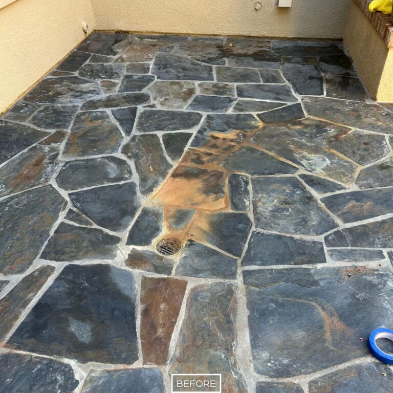 Before restoration of slate patio with heavy stains and buildup in Irvine