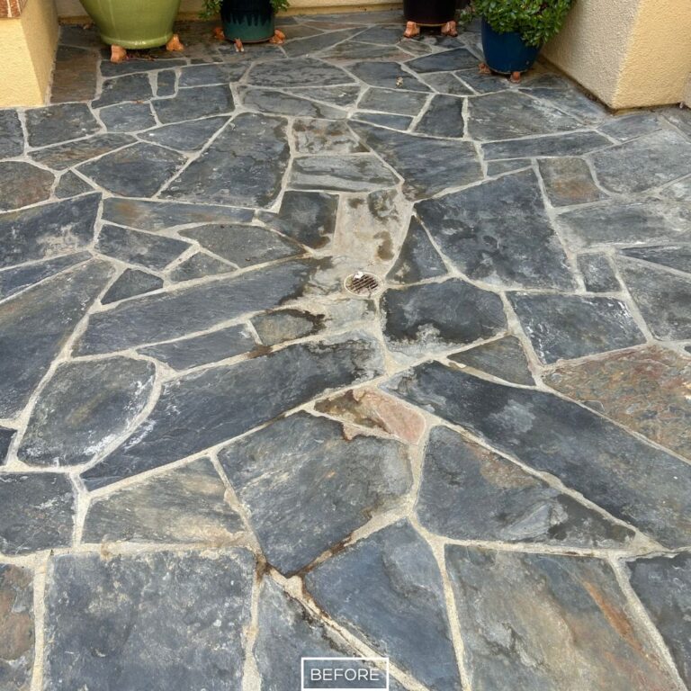 Discolored slate surface with grout residue before cleaning in Irvine