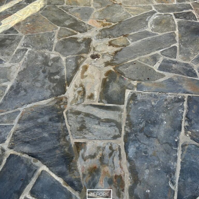 Close up of stained slate near drain before restoration in Irvine