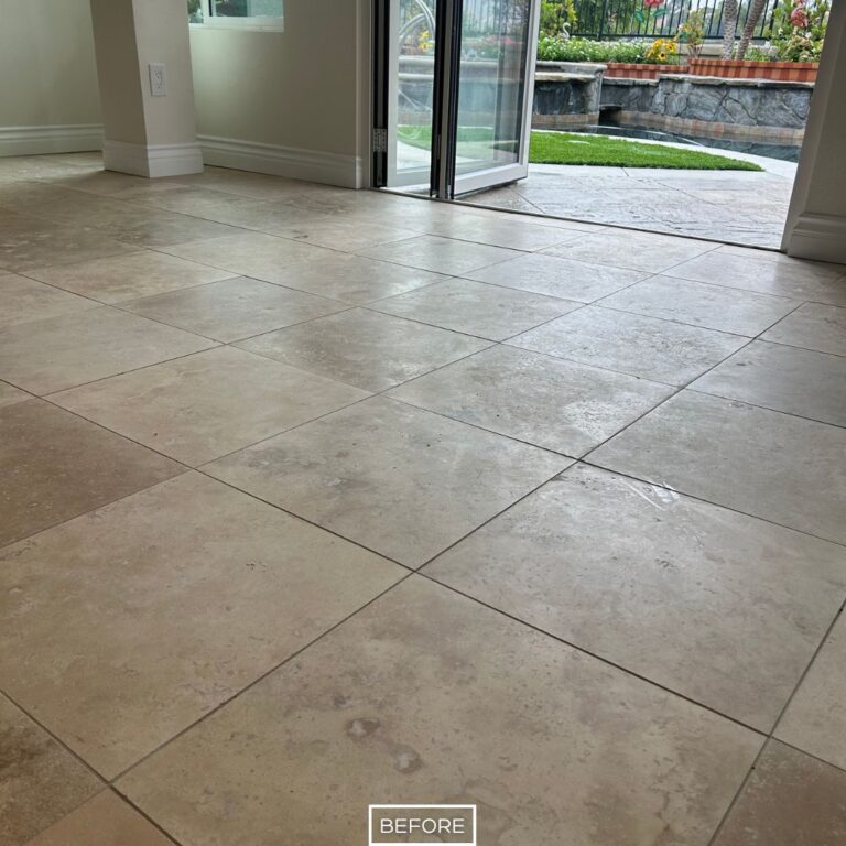 Before restoring the travertine floor in Dana Point with dull finish and surface wear